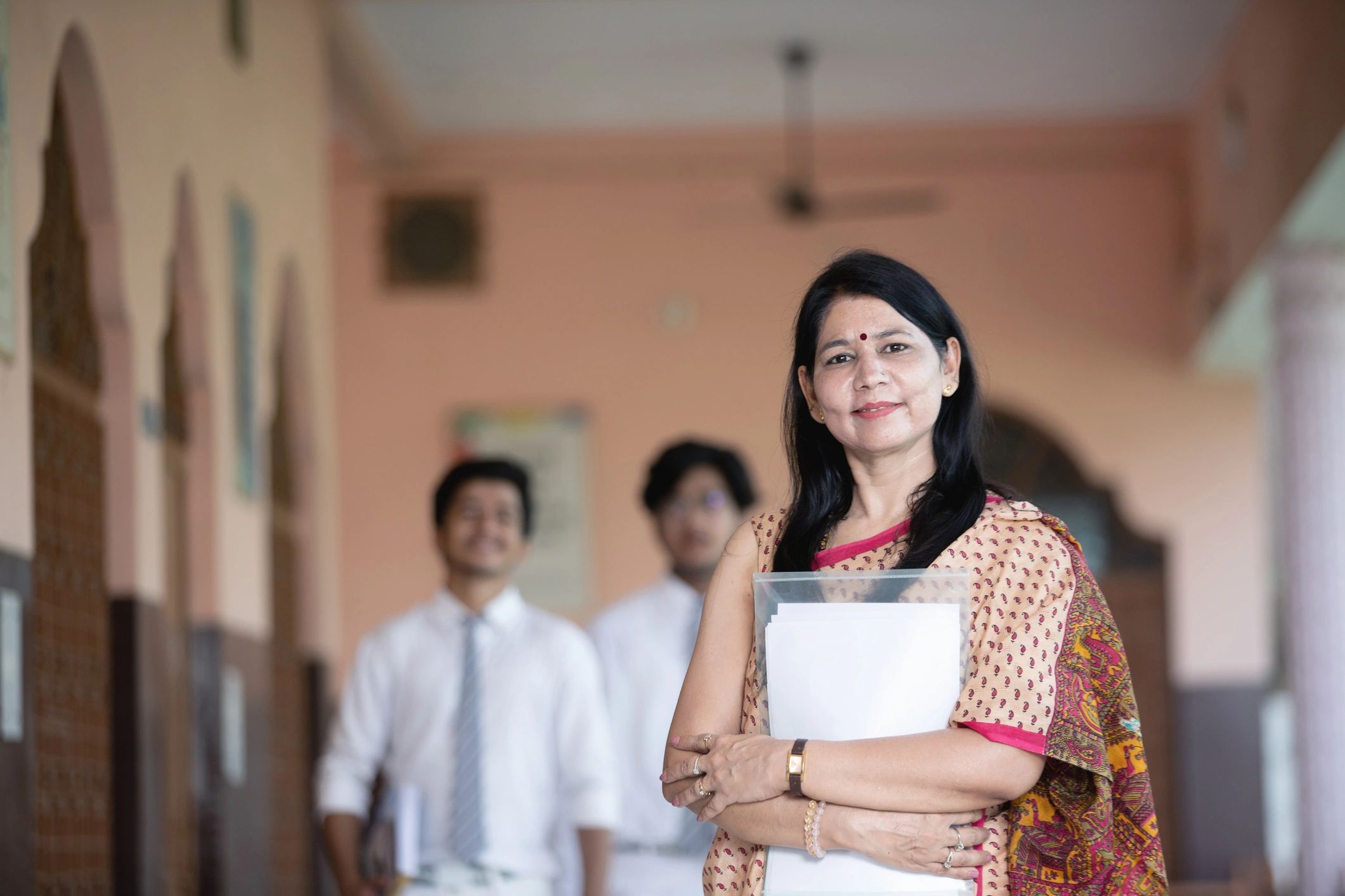 Indian teacher with students in a school setting