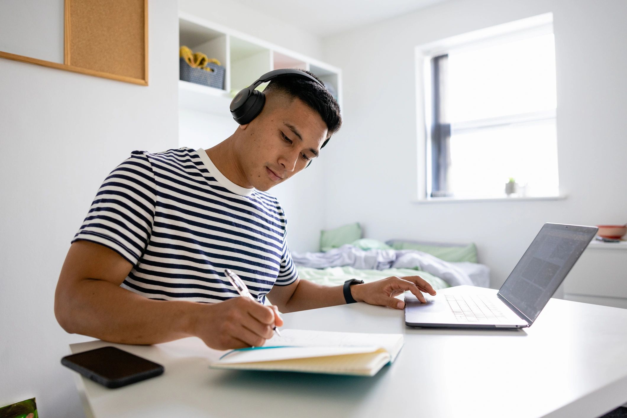 Student studying on a laptop with headphones